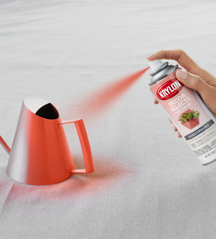 spray painting a metal watering can with Decor Selects
